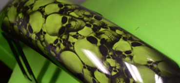 picture of a metal object that was hydro dipped with a green skull design