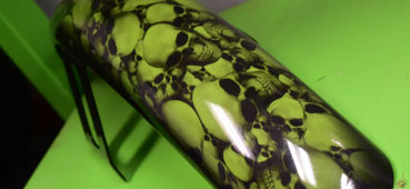 picture of a metal object that was hydro dipped with a green skull design