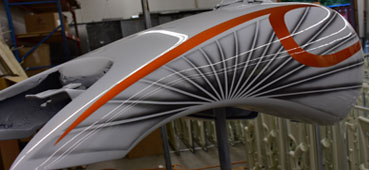 picture of a hydro dipped motorcycle gas tank with white orange and grey swirl design water transfer printed onto it